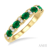 1/6 Ctw Oval Shape 4x3 MM Emerald and Round Cut Diamond Precious Band in 14K Yellow Gold